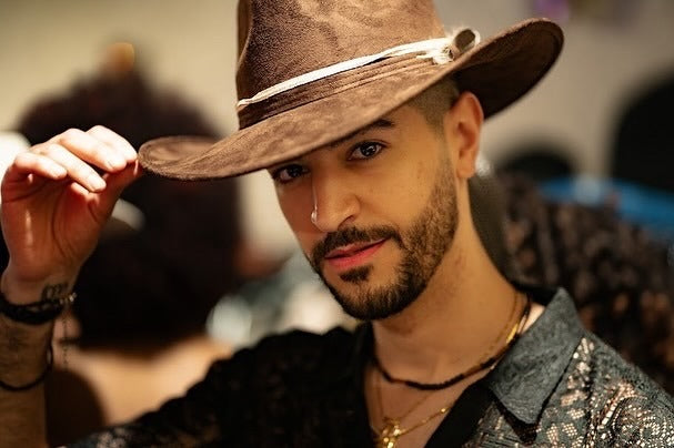 Guest tipping his Numa hat at Georgia Fashion Week